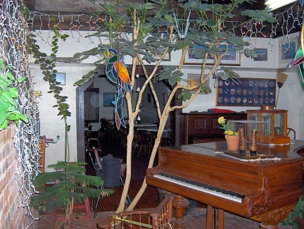 Griggs' dining rooms greet visitors with several pianos and antique furniture