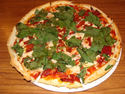 Sun dried tomato and spinach pizza