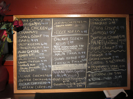 Sheesh Mahal posts their daily menu on a blackboard